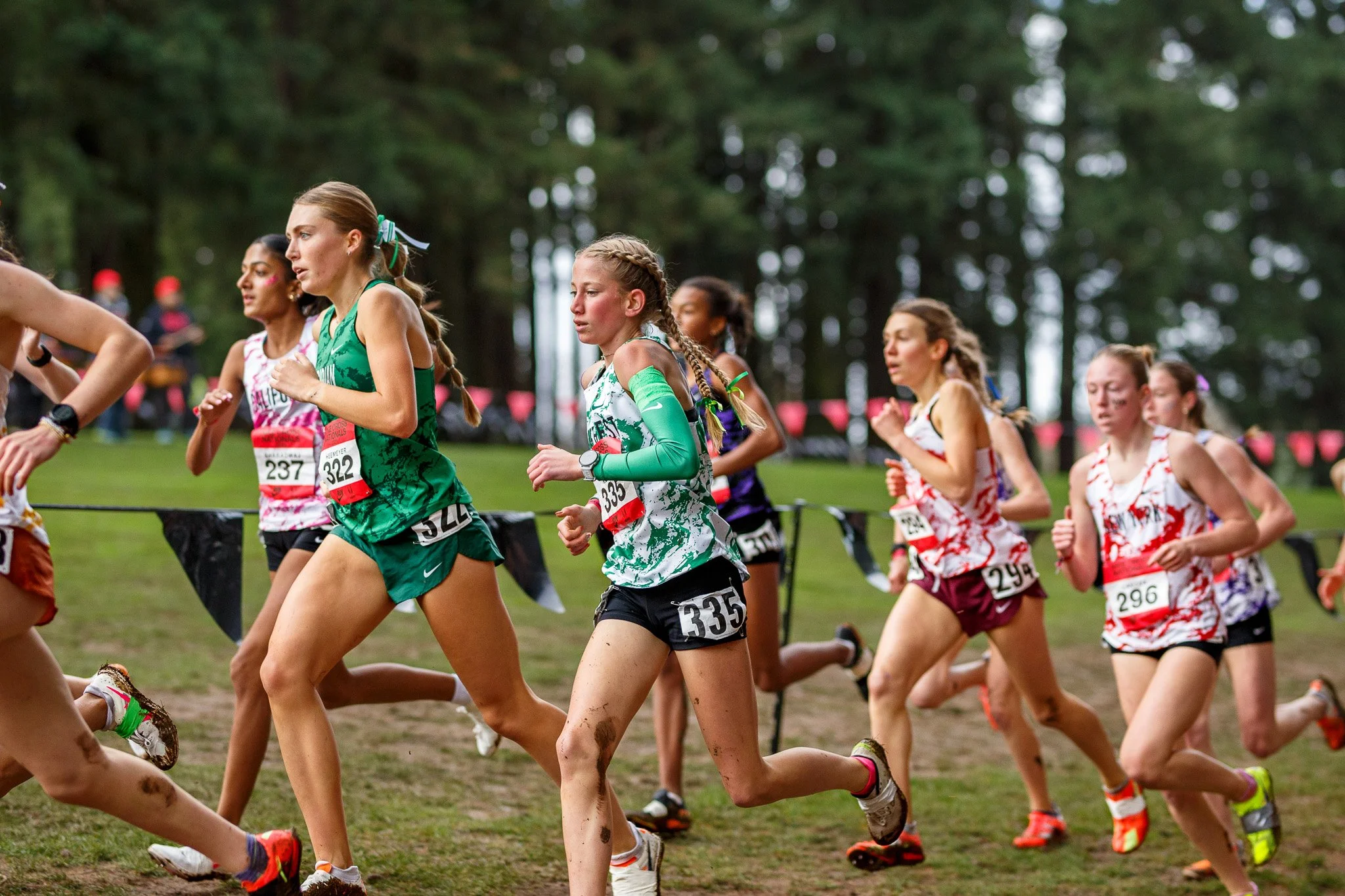 Exhausted athletes catching their breath in the finish chute after the 2025 Nike Cross Nationals in Portland.