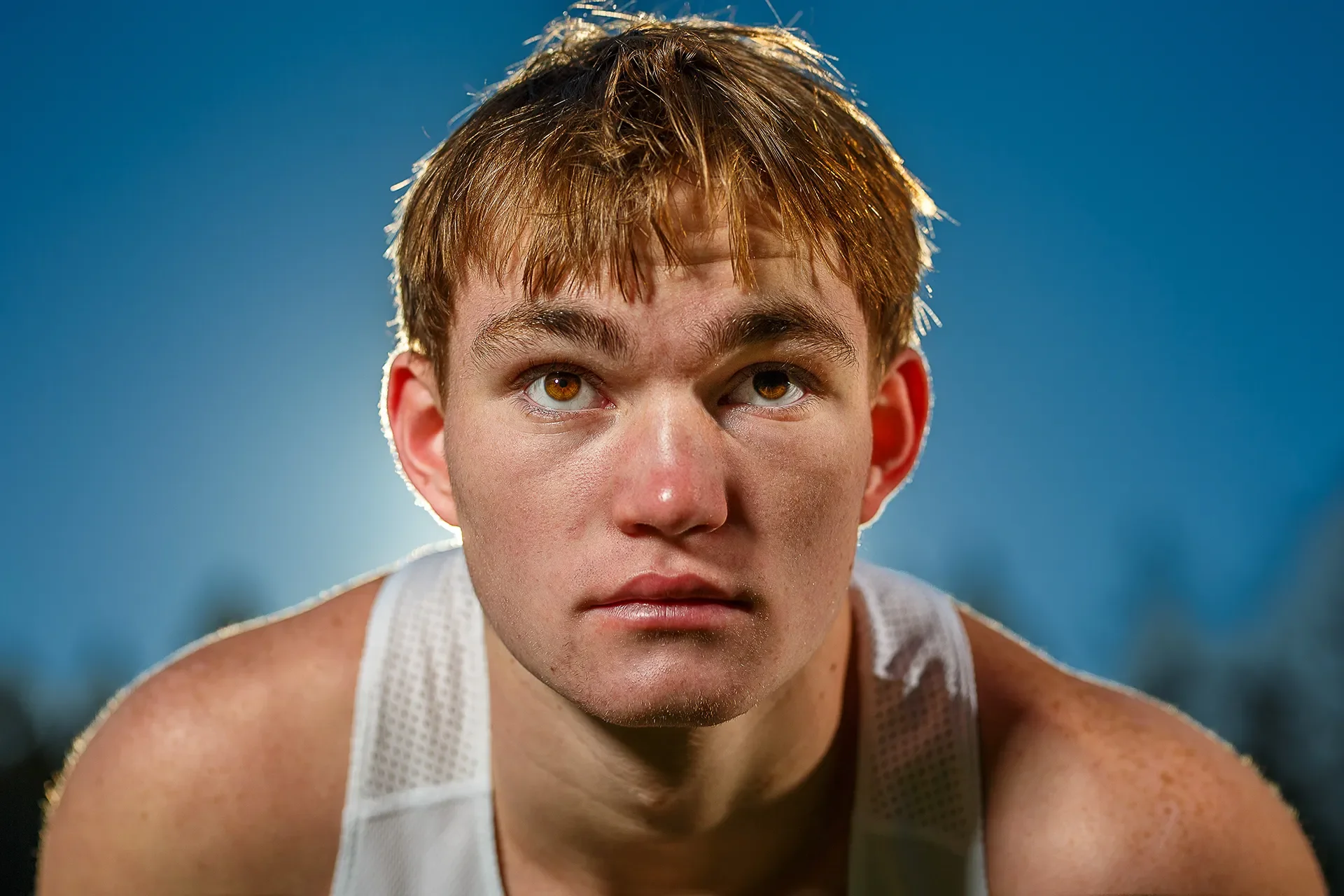 Close-up portrait of Max Dower, intense expression, backlit by sun