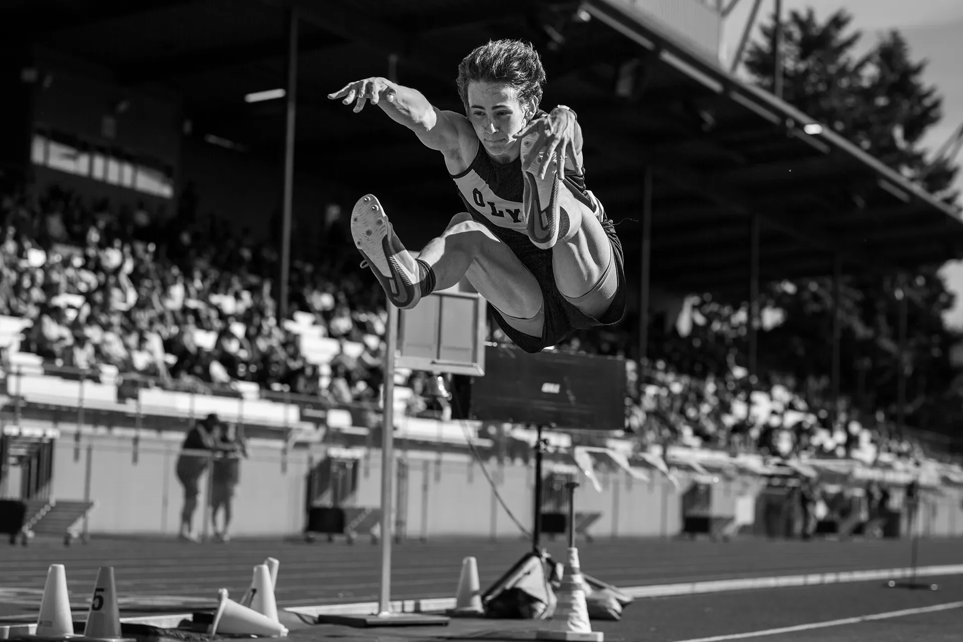 Olympia long jumper in flight at the 2026 district championships