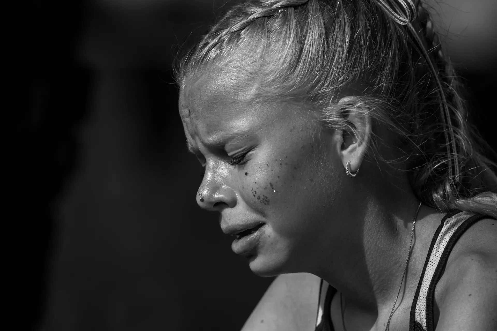 Black and white editorial photography of exhausted runner