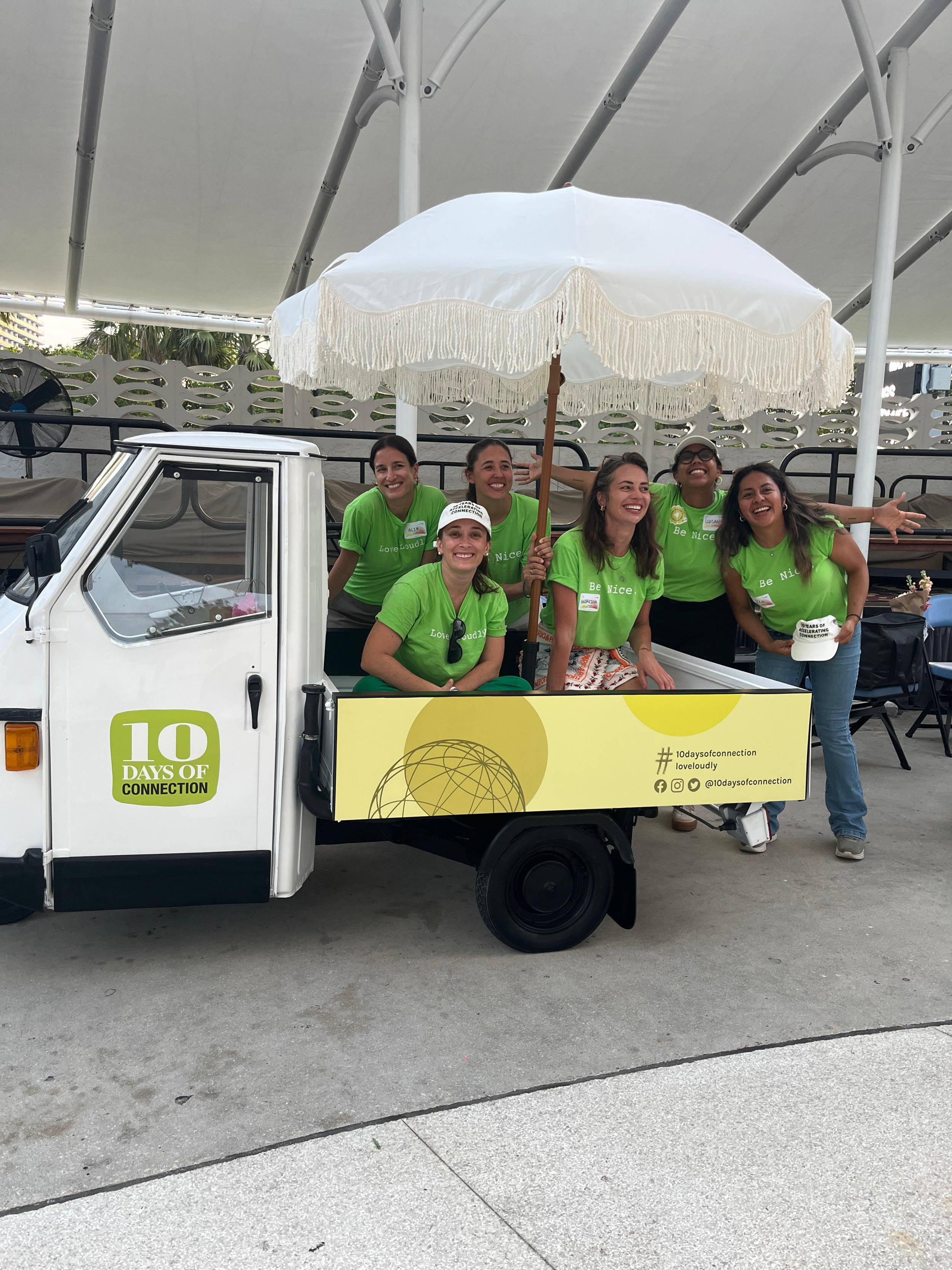 The Radical Partners team in the 10 Days of Connection truck under a white umbrella
