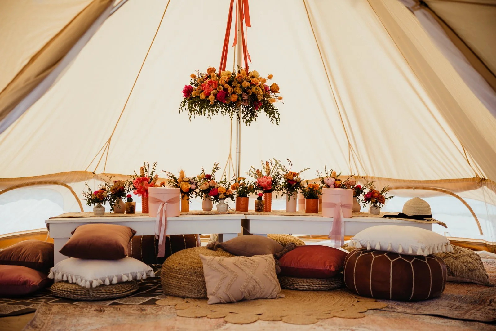 A warmly styled tent and gathering table beside a Wisconsin lake. Dave Stremikis Photography, Copper Feather / WedPlan editorial.