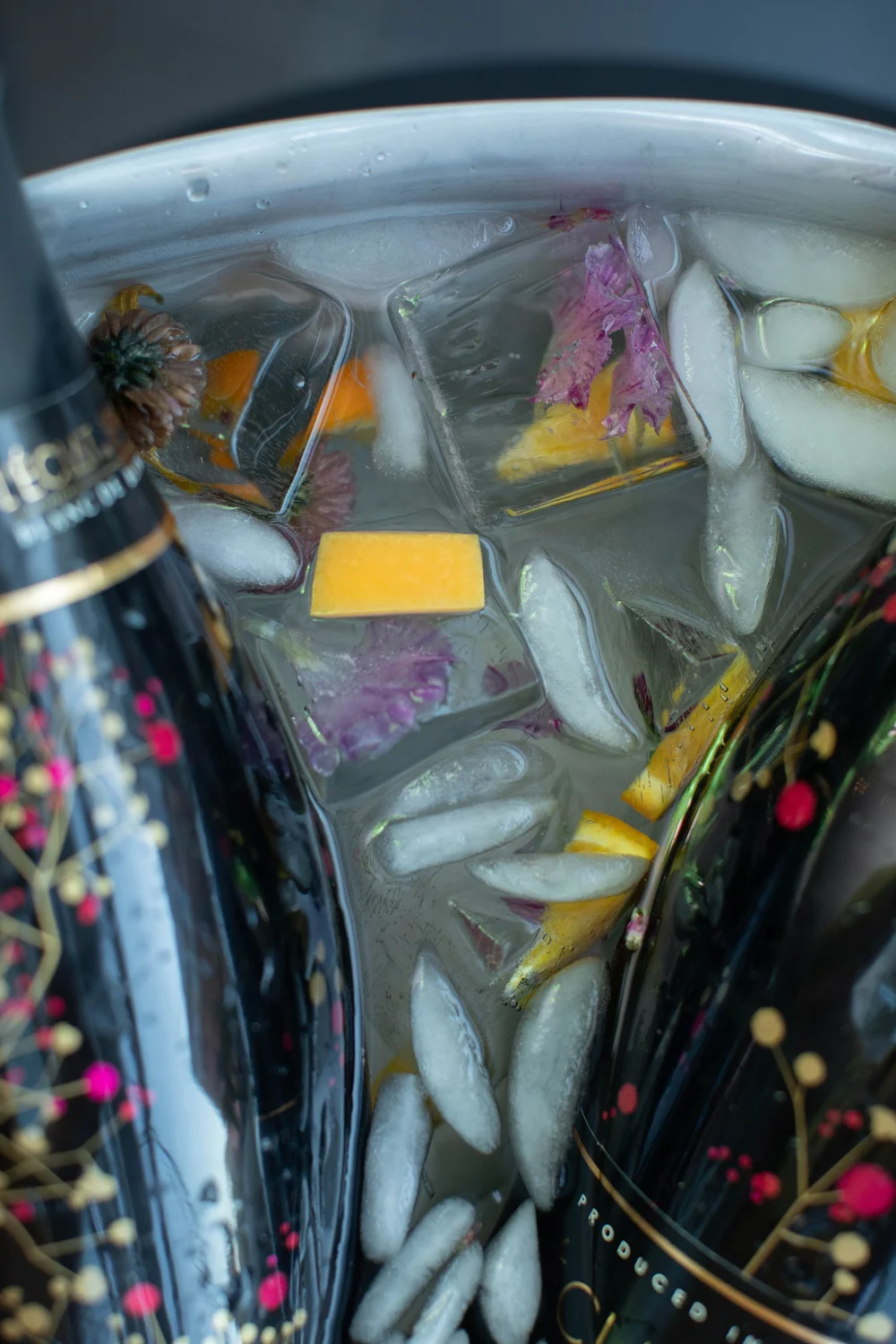 Citrus and flower-filled ice at the drinks table. Photograph by Kuffel Photography.