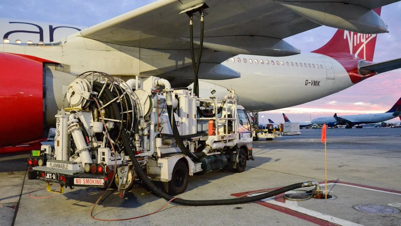Commercial jet being refueled at airport gate amid surging fuel prices