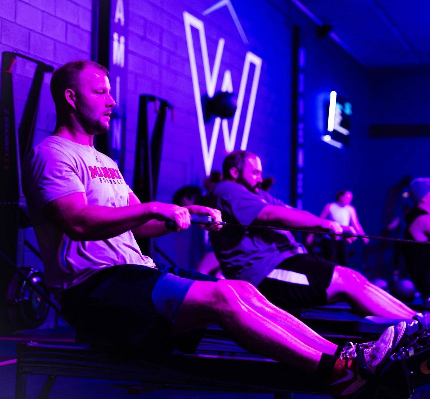 Coach spotting a member on bench press