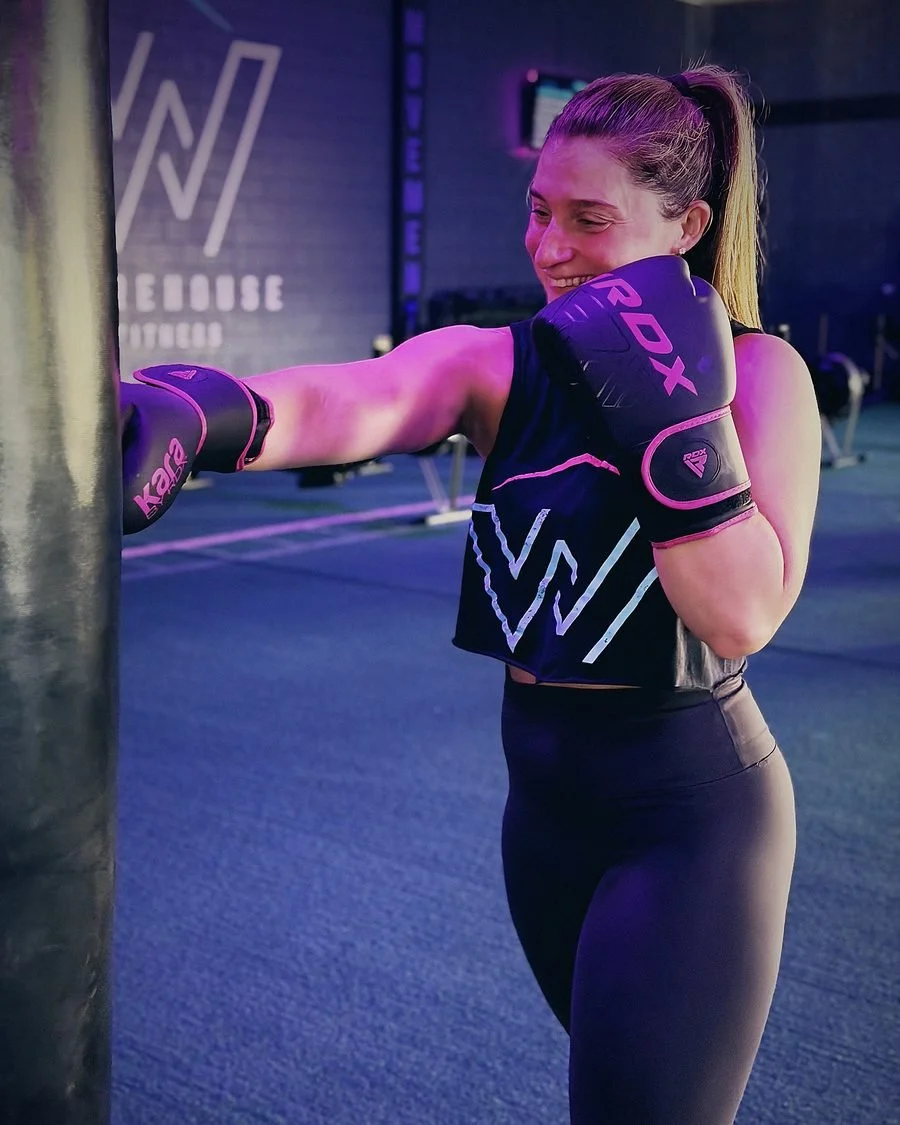 Warehouse member throwing a jab on the heavy bag