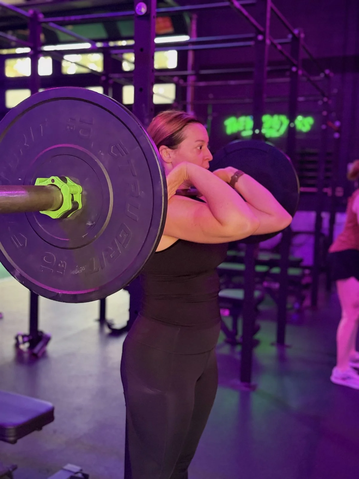 Warehouse member on the rower mid-workout