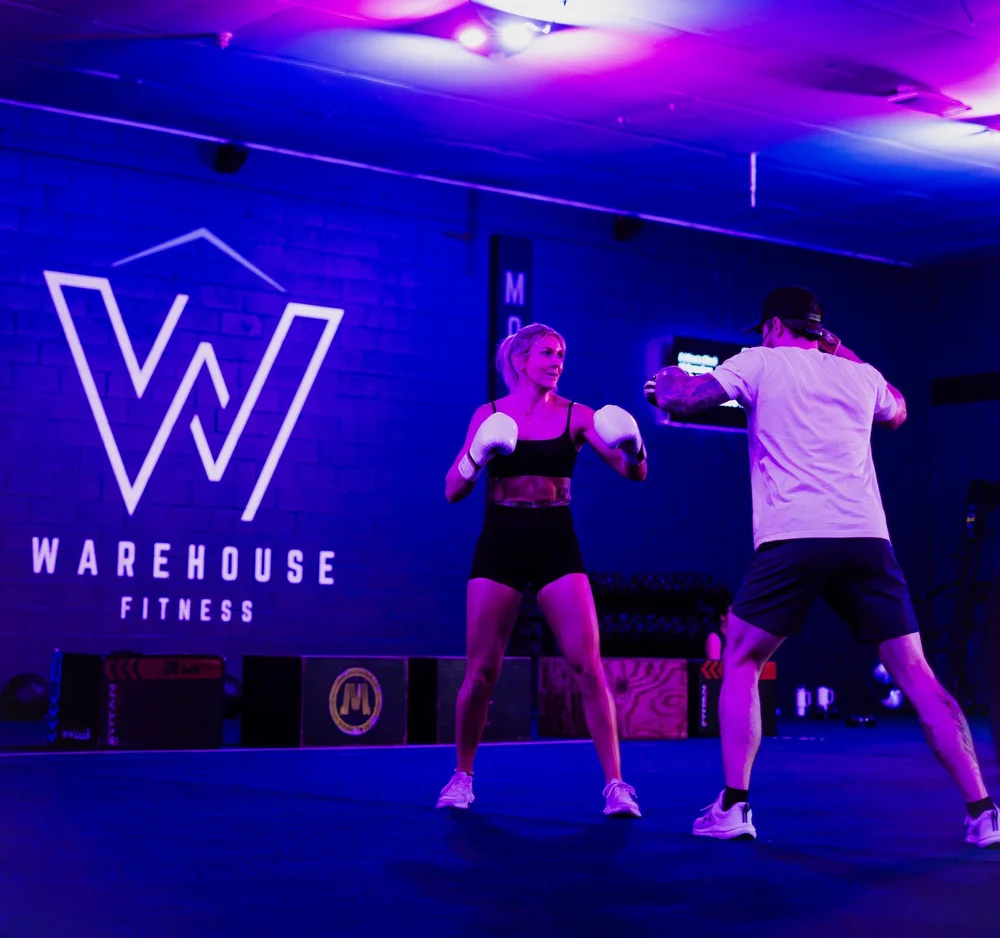 Member in guard stance with boxing gloves