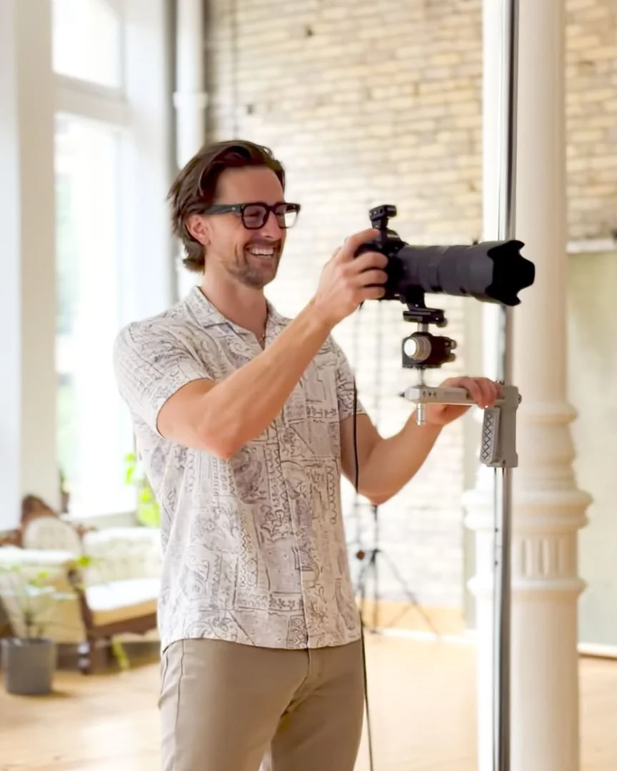 Mark Eadie photographing tethered in the Exchange District studio, laughing behind the camera