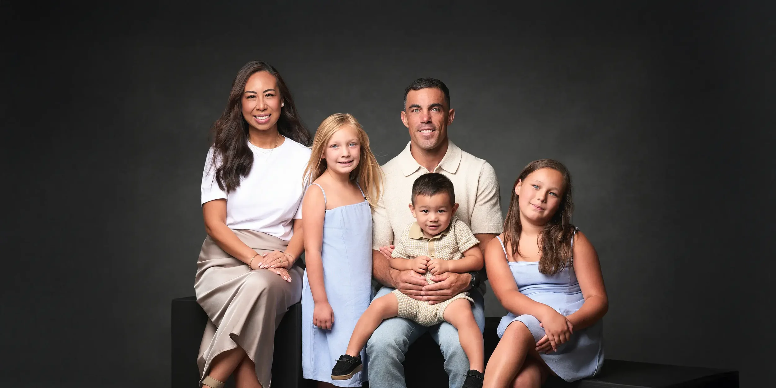 Winnipeg family photography by Mark Eadie — studio portrait of a family of five in cream and lavender