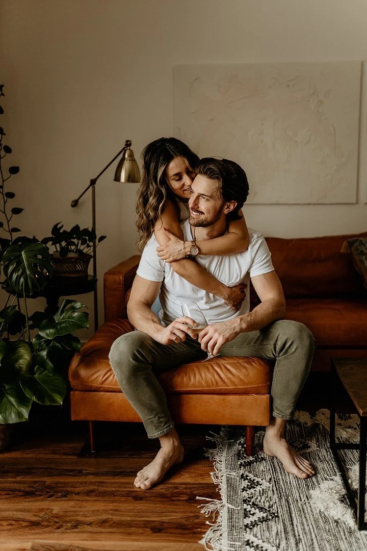 Mark Eadie and his wife Anna at home, photographed on their leather couch