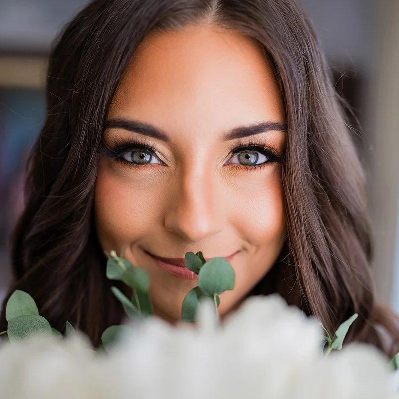 Bridal portrait — bride smelling flowers in soft, flattering light