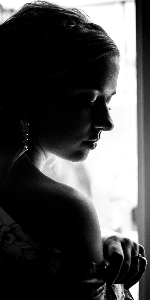 Dramatic bridal portrait — bride in a one-shoulder gown, black and white