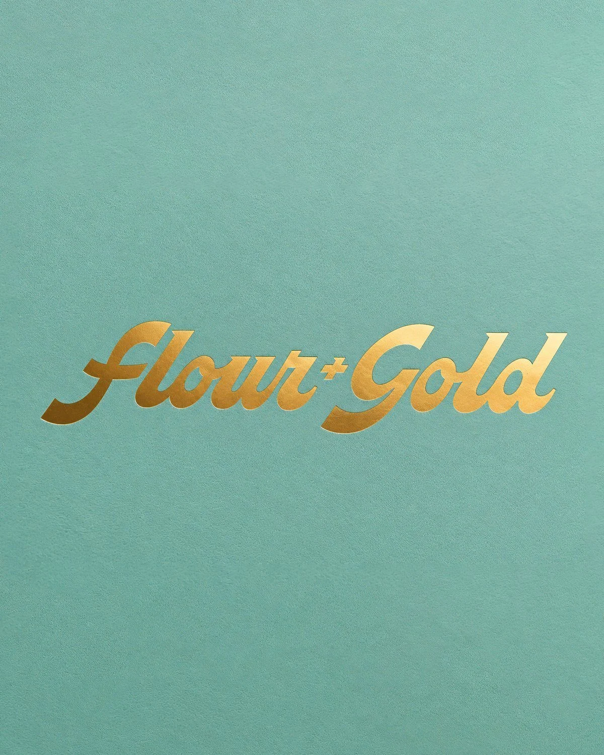 The new Flour + Gold script logo in gold foil on mint paper