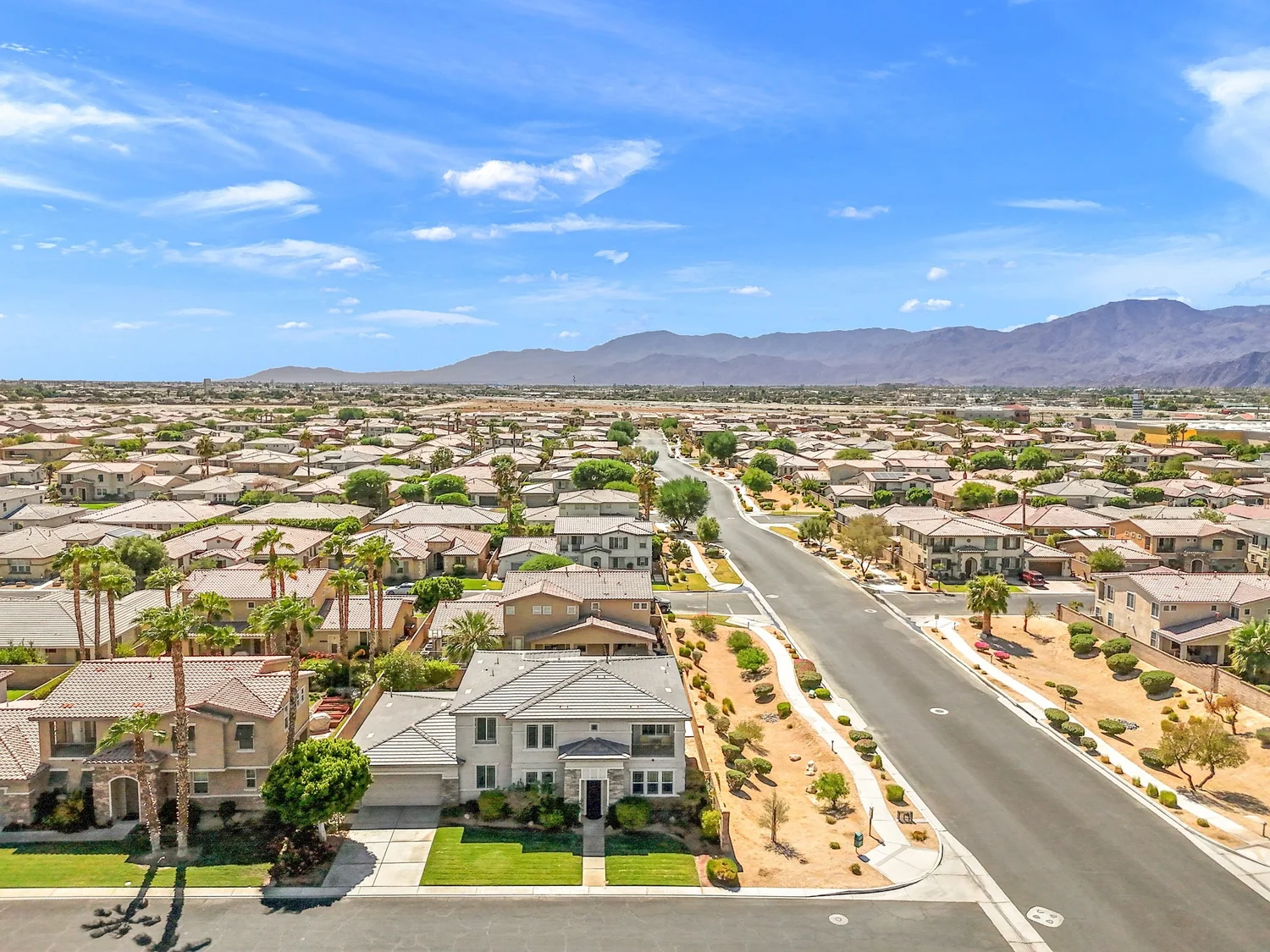 A residential street of single-family homes in Indio