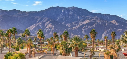 Cathedral City rooftops and palms below the San Jacinto Mountains