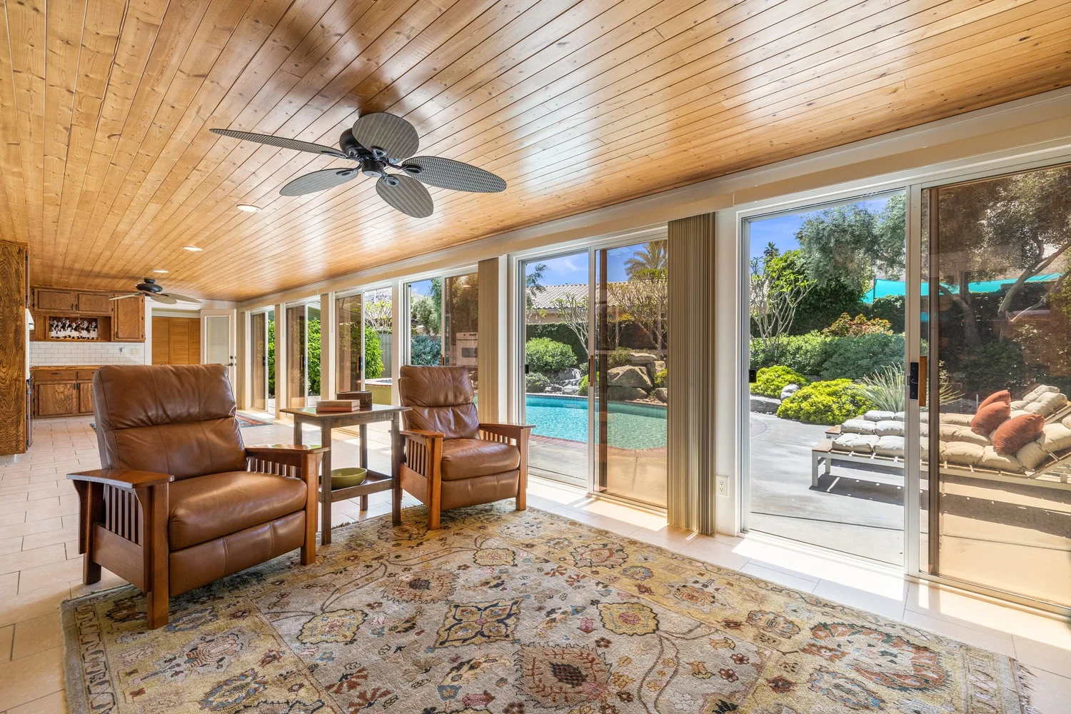 A furnished living room opening to a pool in Cathedral City