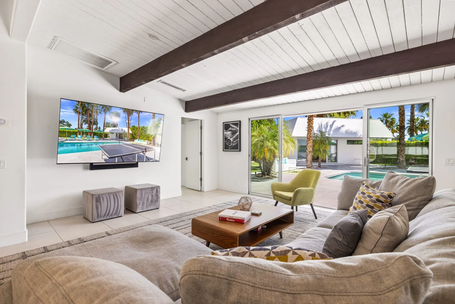 A furnished living room opening to a pool in Palm Springs