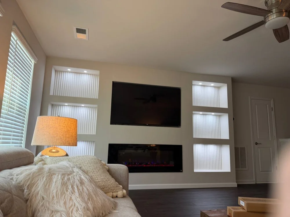 TV media wall with lit recessed niches and electric fireplace, Charlotte NC
