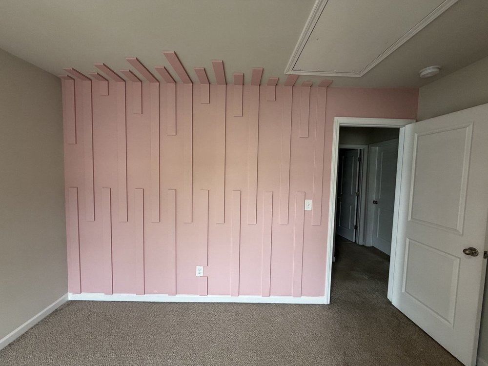 Pink accent wall with layered vertical trim, Charlotte NC