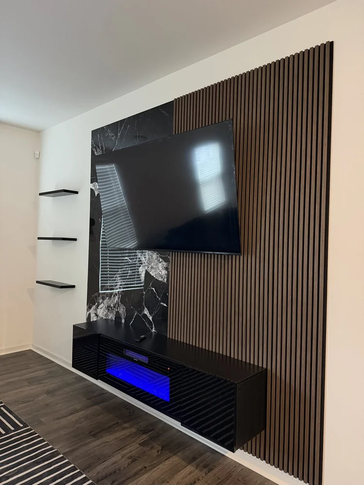 Wood slat and black marble-look TV media wall with fireplace console, Charlotte NC