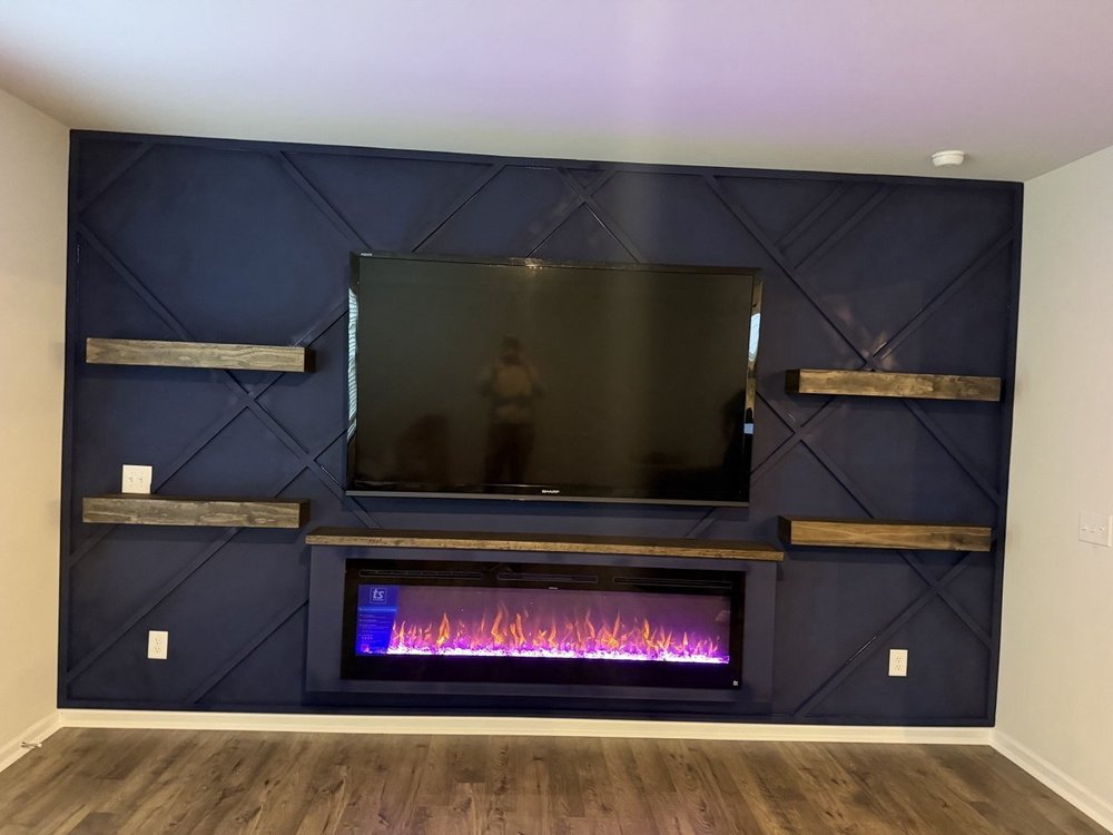 Navy geometric fireplace wall with floating wood shelves, Huntersville NC