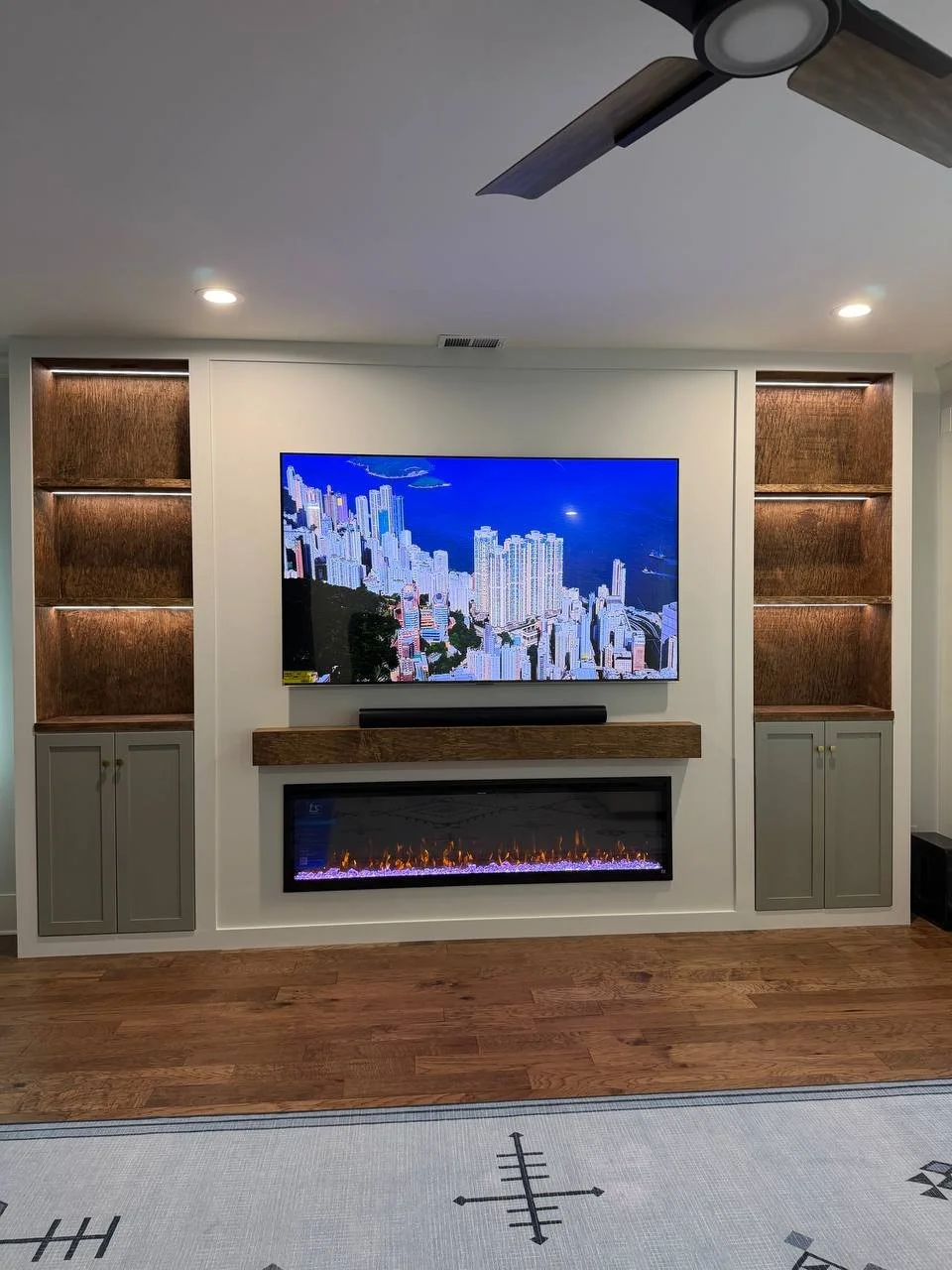 Built-in TV media wall with cabinets and electric fireplace, Charlotte NC