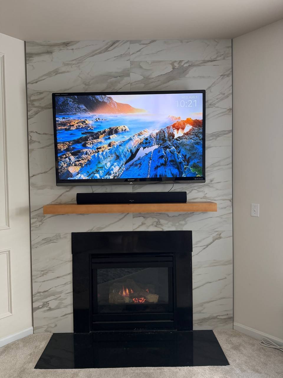 Marble-look fireplace surround with wood mantel and black hearth, Charlotte NC
