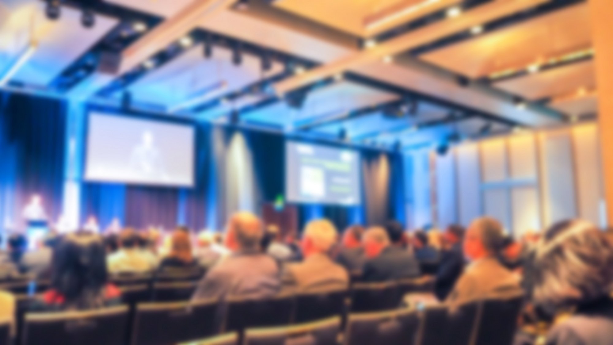 View of people listening to a speaker at a conference