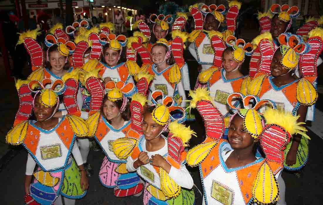 Colorful photo of group of students wearing costumes at Junkanoo.