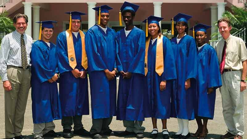 Group shot of graduates in school blue graduation gowns.