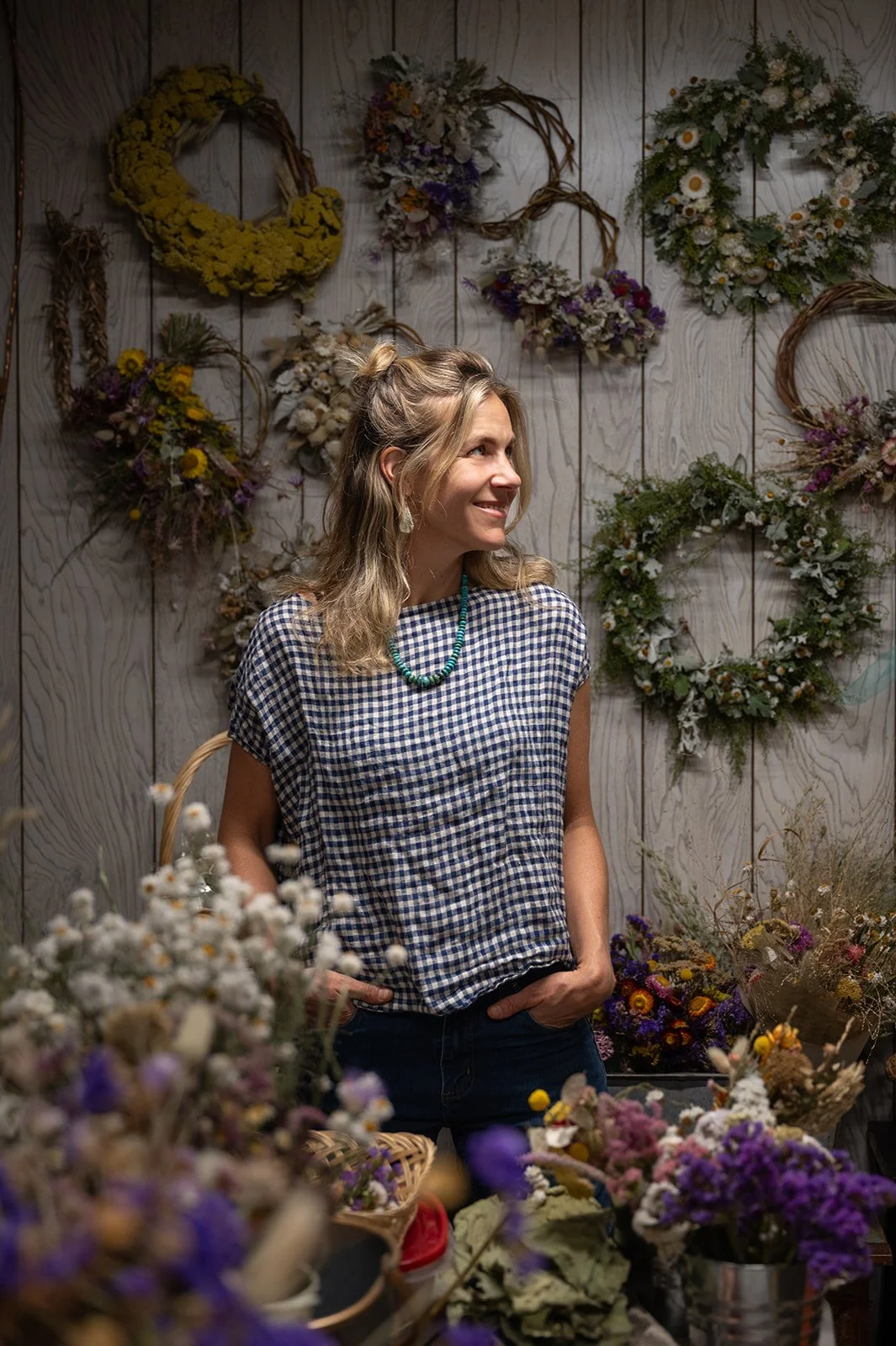 Renee Stewart of Stewberry Flower Farm surrounded by dried wreaths