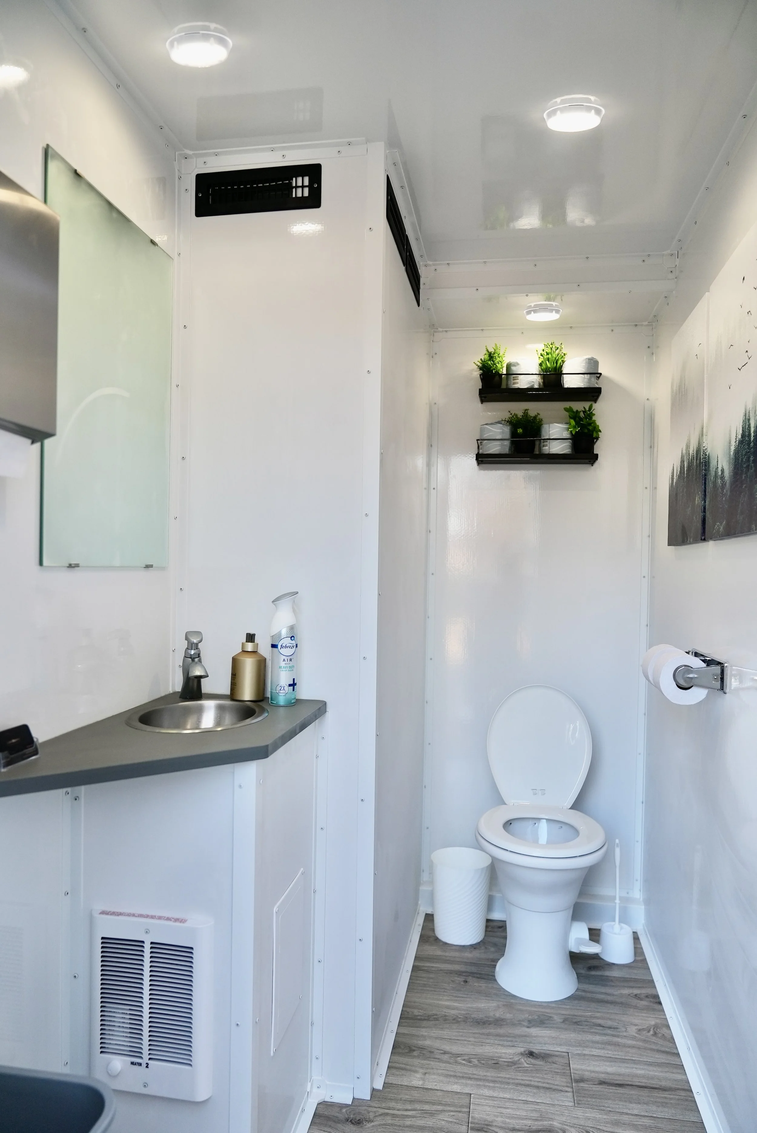 Luxury restroom trailer interior with real finishes and flushing toilets