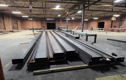 Steel sections arranged on the fabrication floor