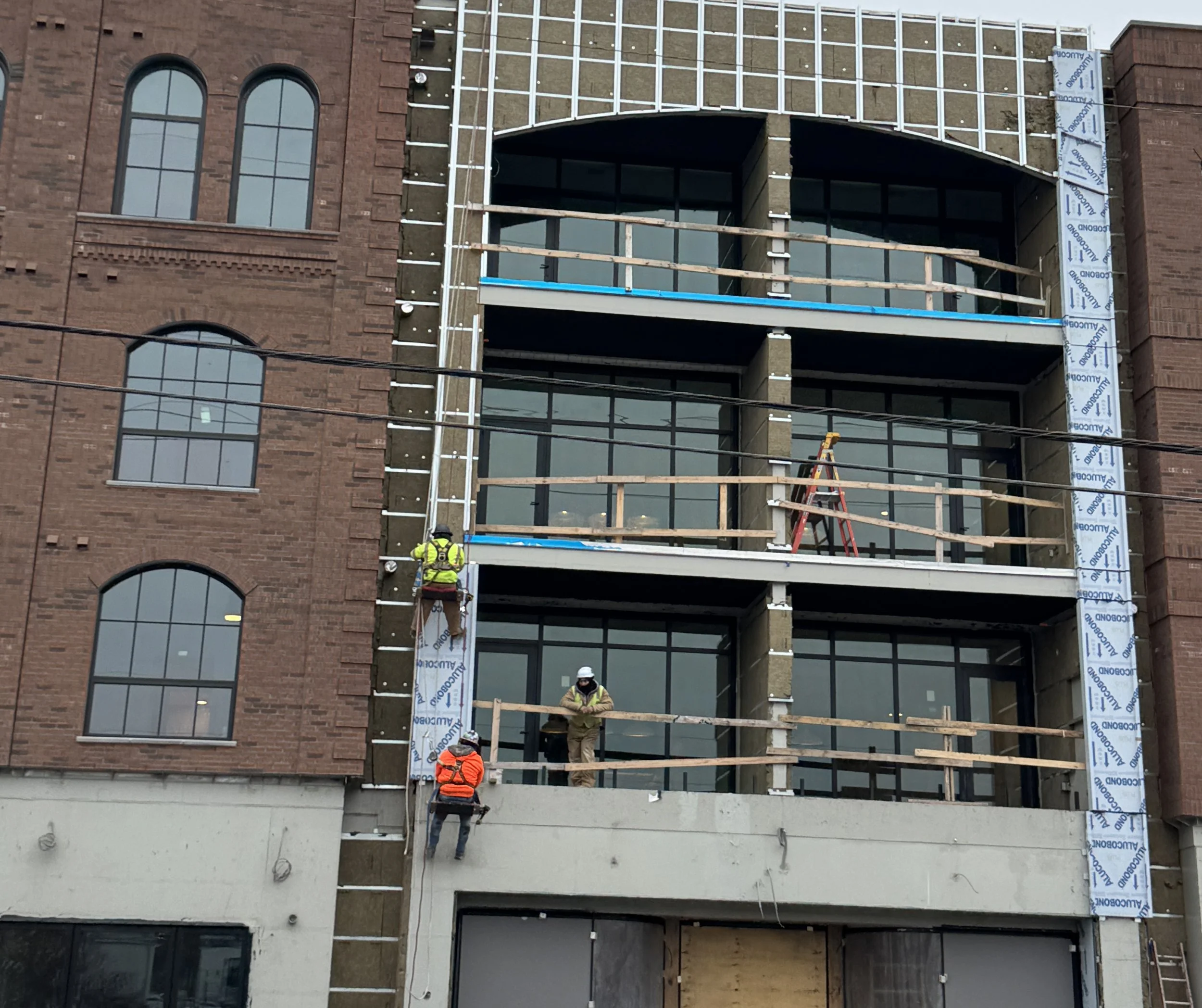 Mixed-use commercial building under construction with exterior framing and window openings
