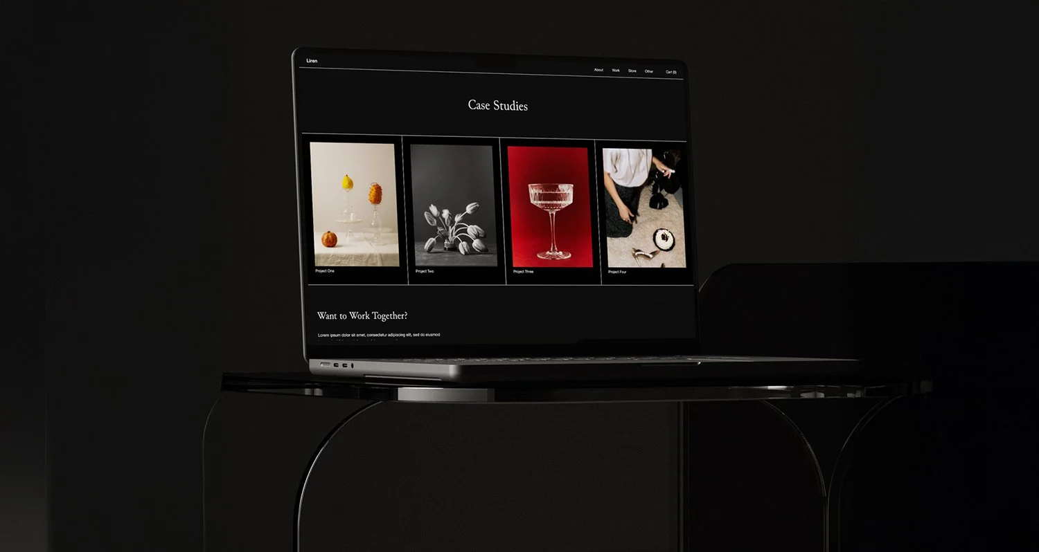 A website design displayed on a laptop screen.