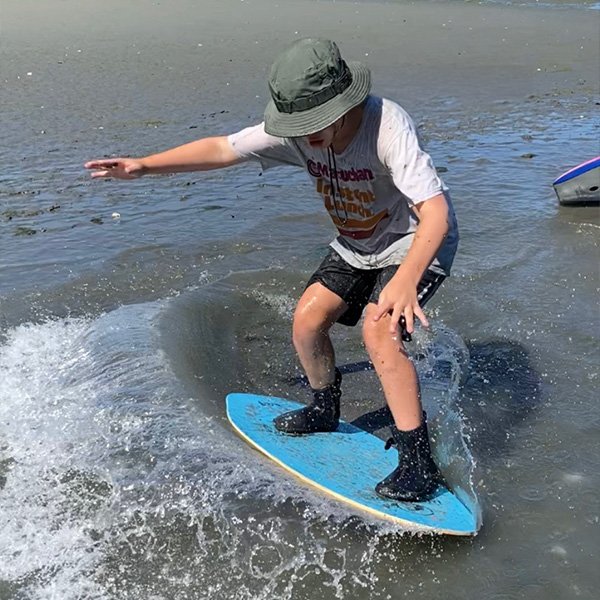 A boy skimboarding.