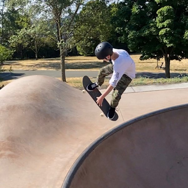 Boy skateboarding in a bowl.