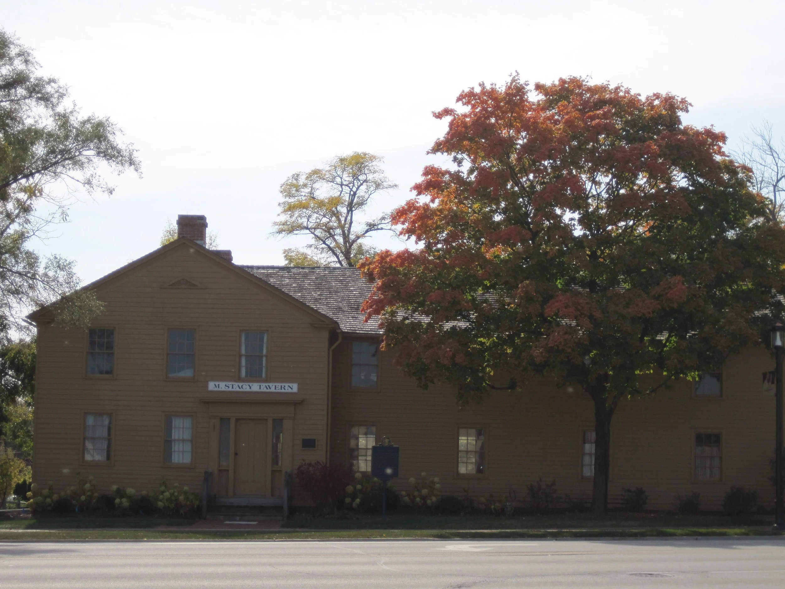 Stacy's Tavern, an 1846 stagecoach inn in Glen Ellyn, with an autumn maple in front