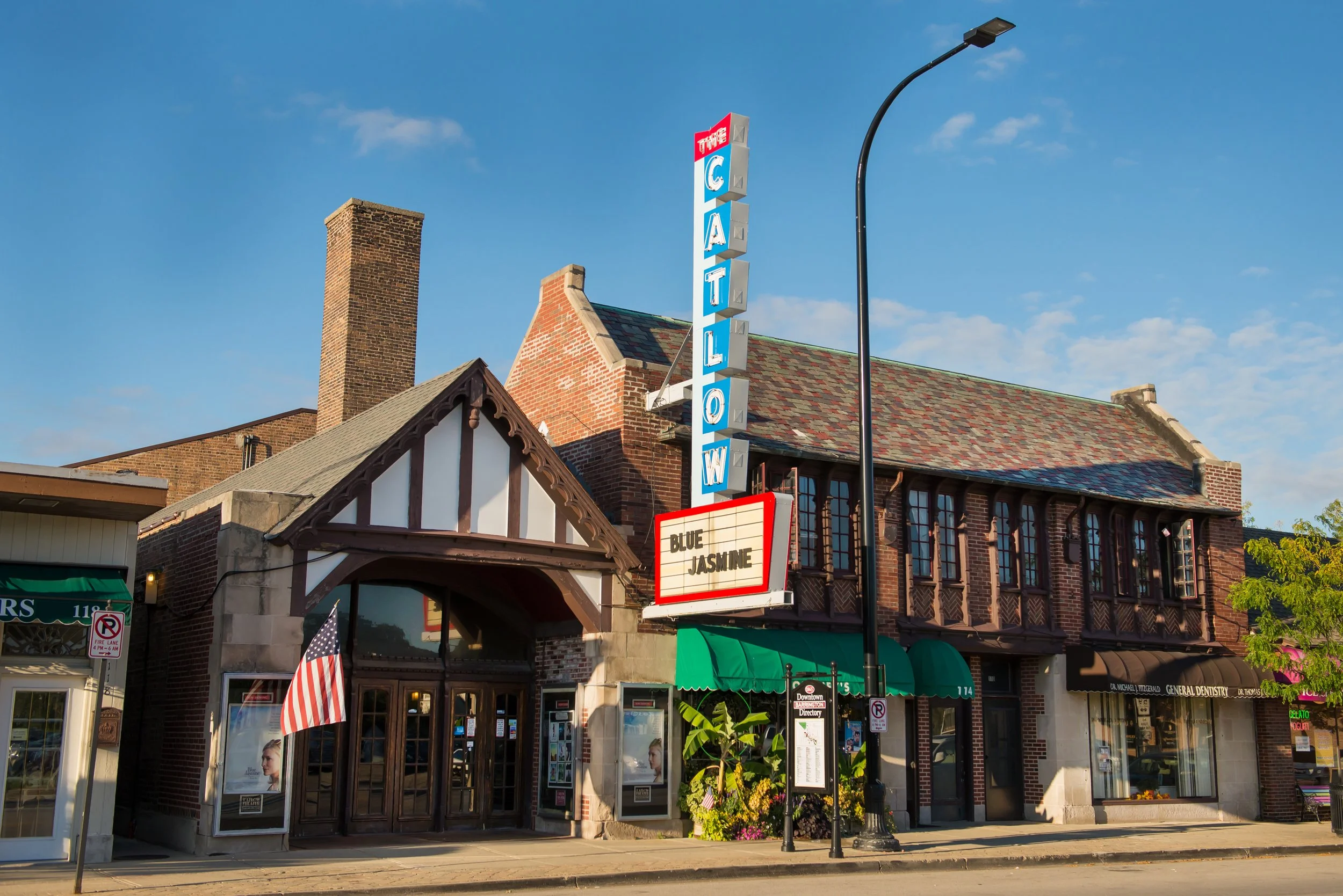 The Catlow Theater facade and vertical marquee sign on West Main Street in Barrington, in evening light