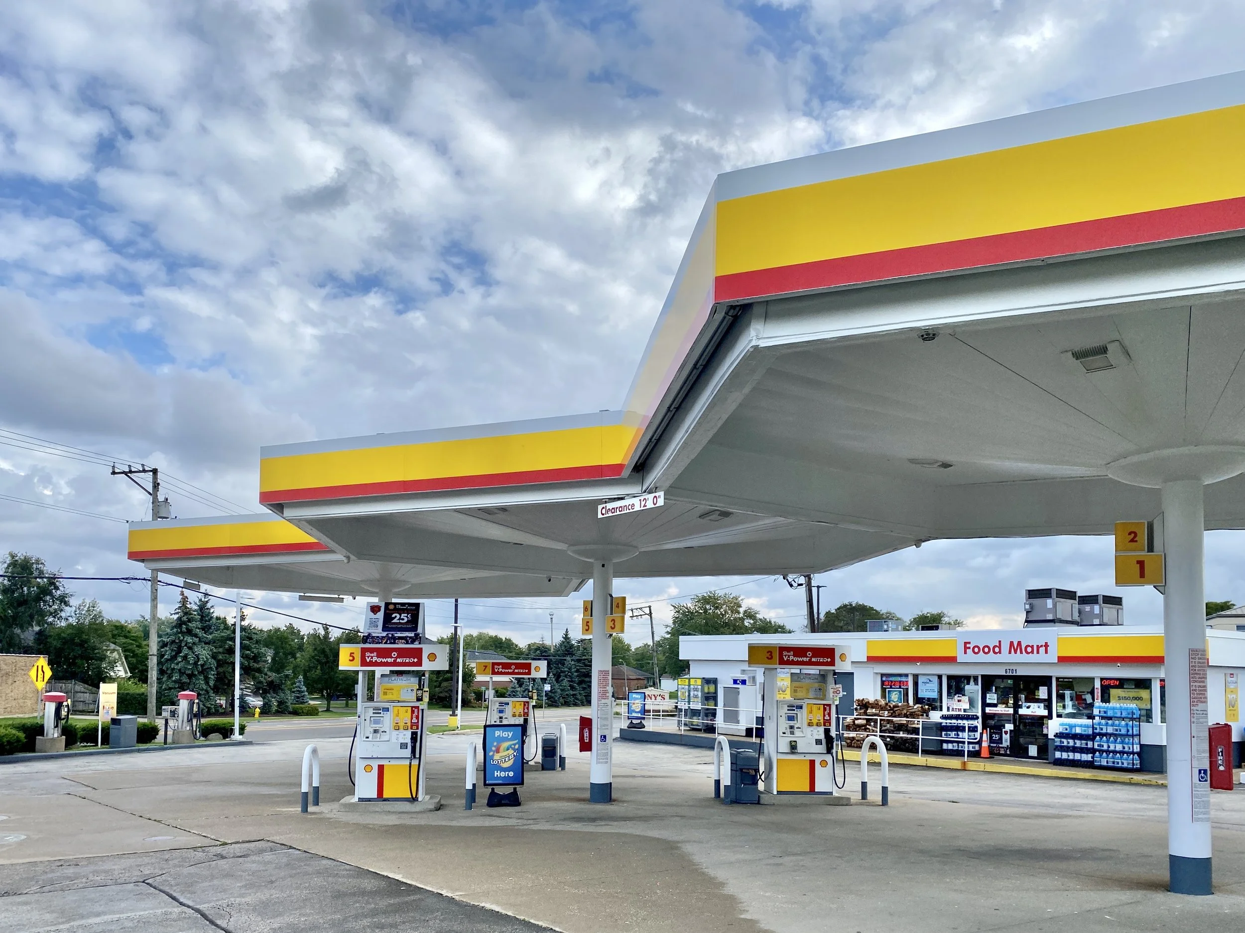 A Shell station's yellow and red canopy on old Route 66 at Willow Springs Road in Countryside, under a cloudy sky