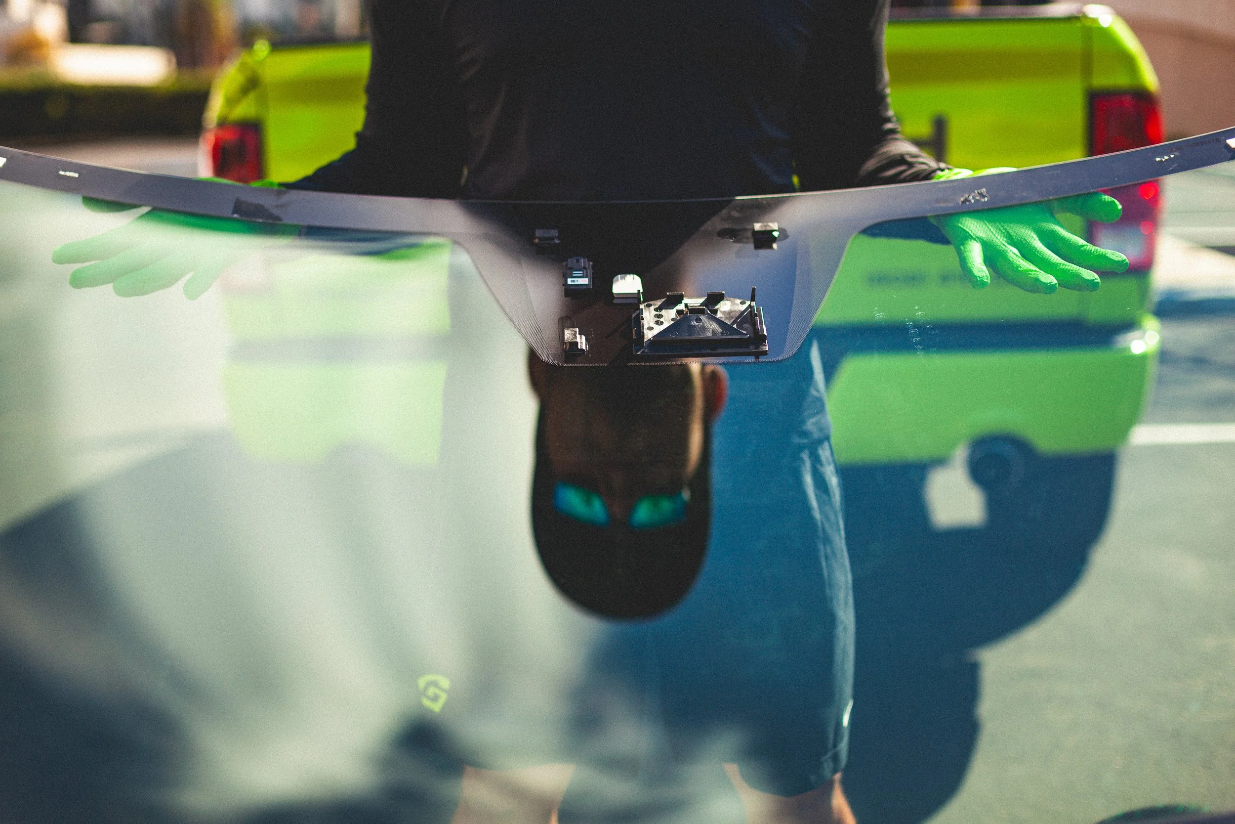 Windshield with specialty sensor being prepared for installation