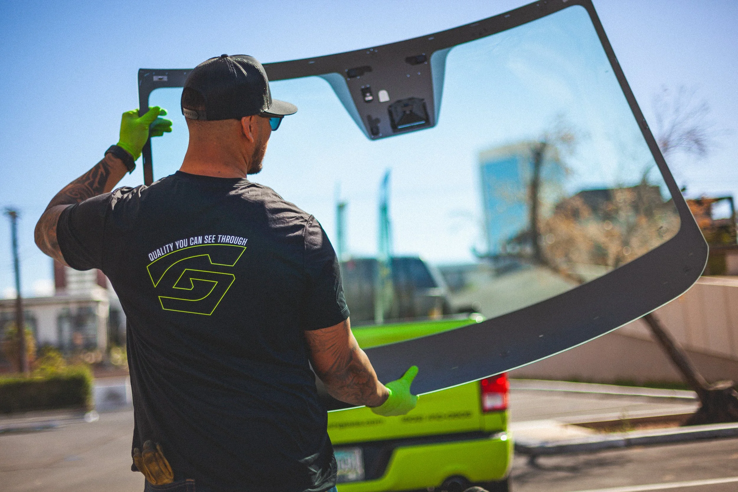 Gryath Glass technician carrying a new windshield to be installed