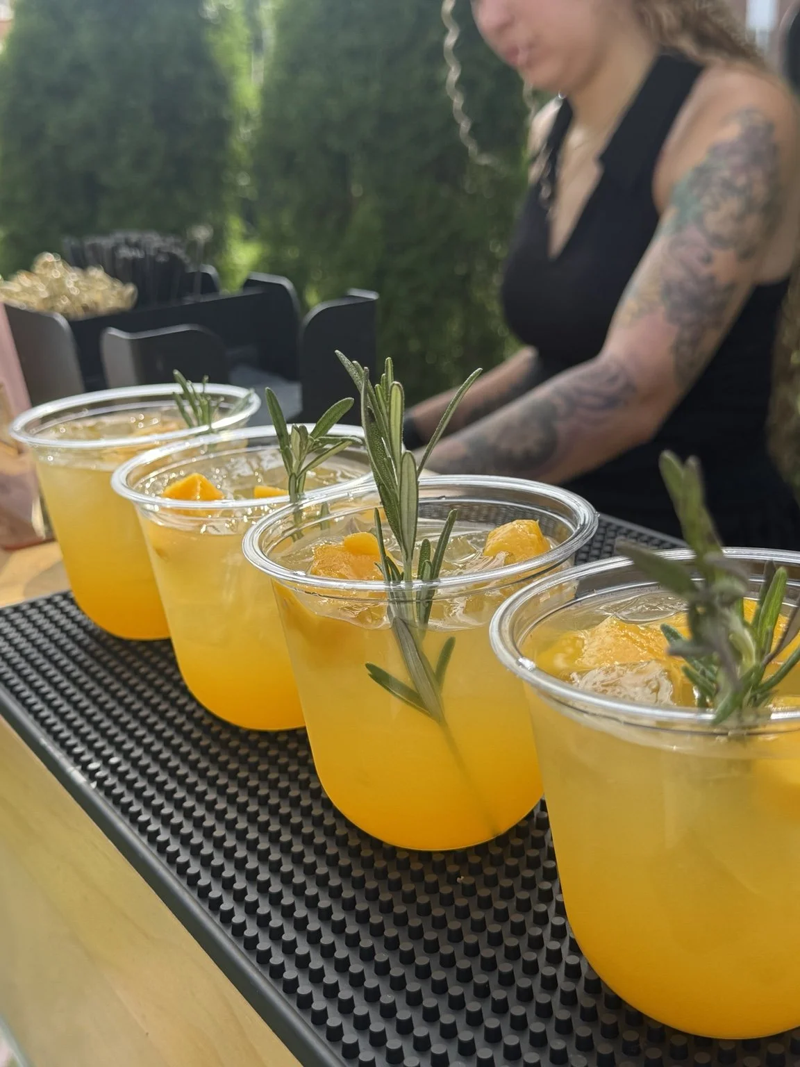 Freshly prepared Mixhaulogy cocktails with orange slices and rosemary