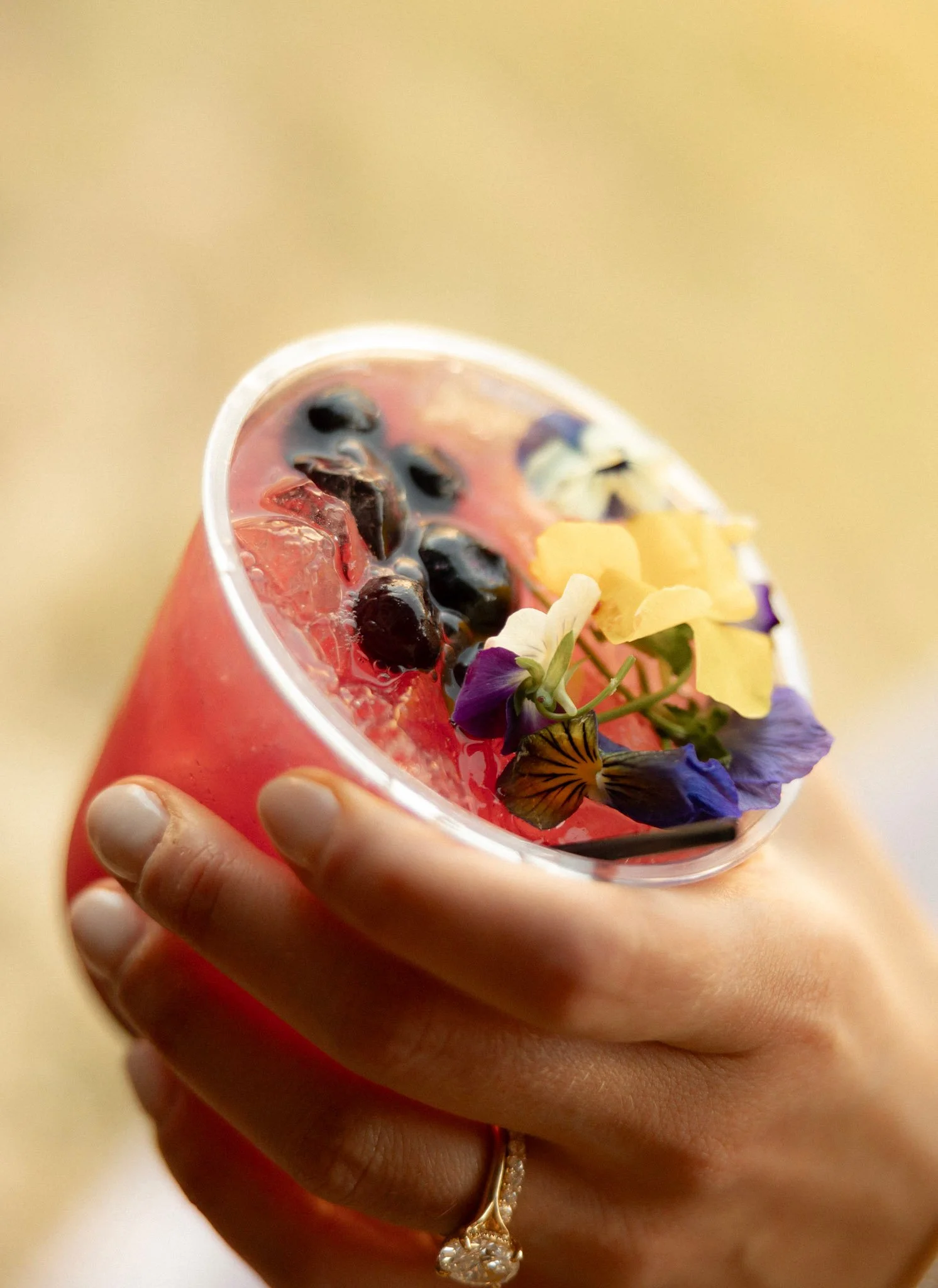 Vibrant berry cocktail with floral garnish