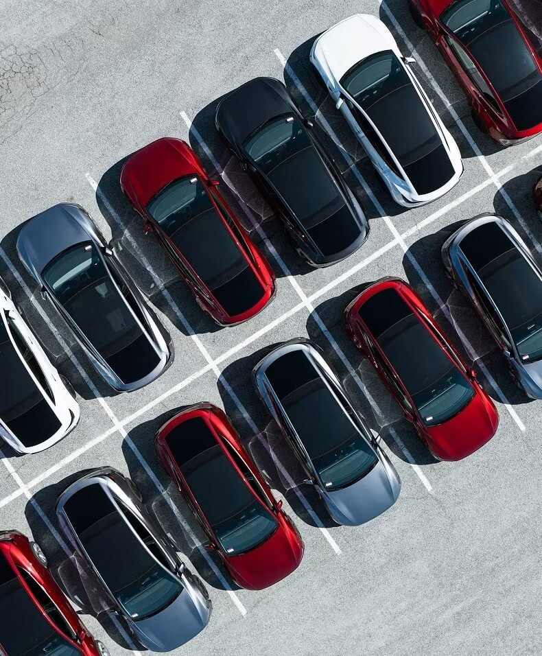 Rows of Tesla vehicles parked in a lot