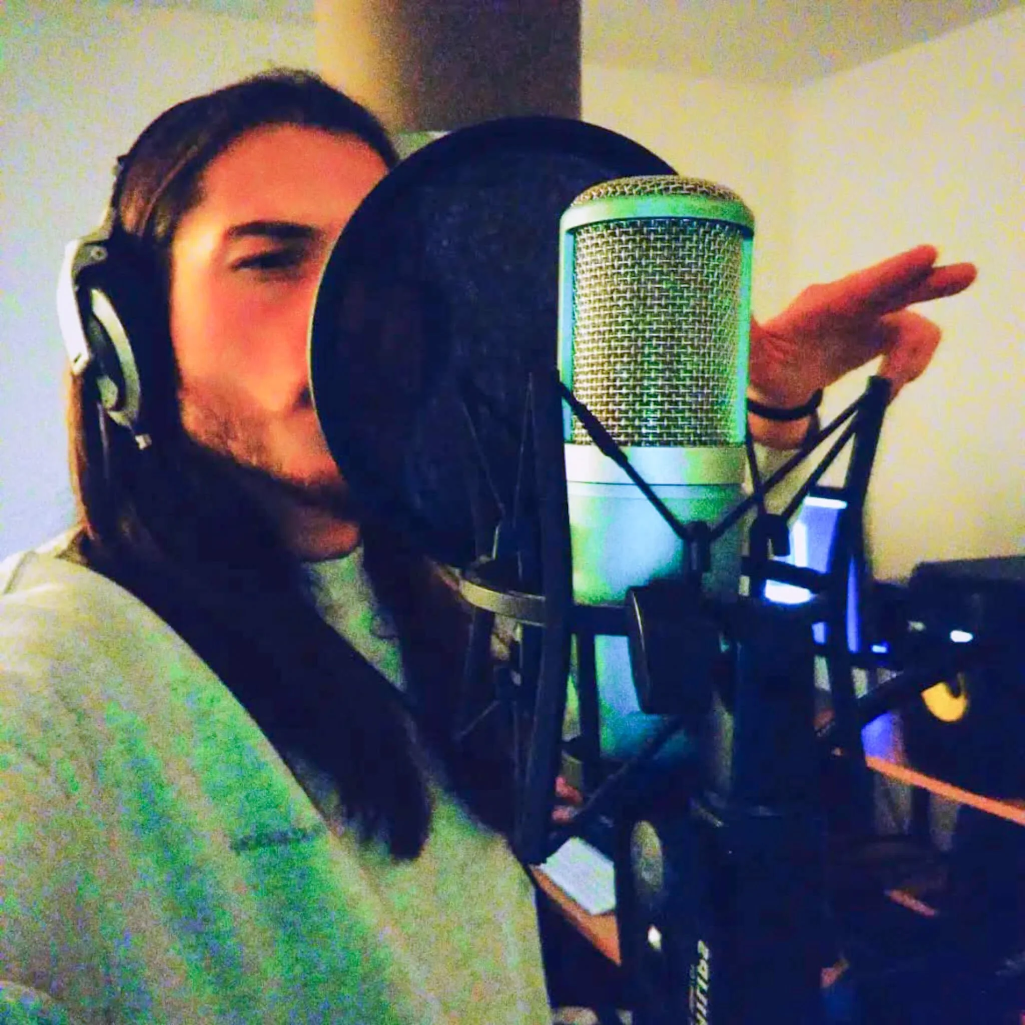 Studio session — mic, booth, and that ready-to-cut posture.