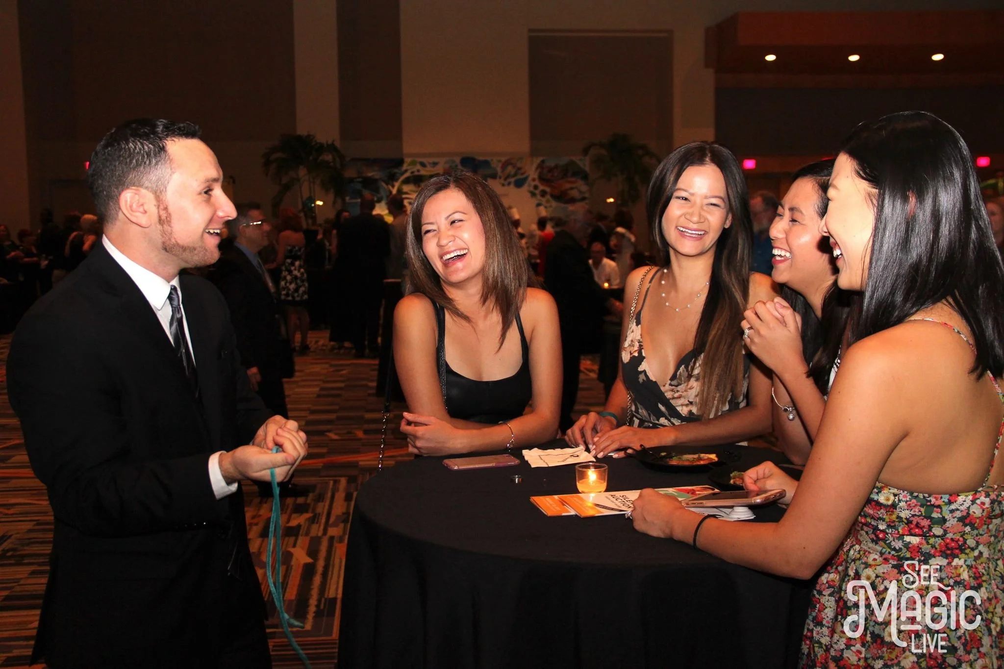 Corporate magician Ari Novick entertaining guests at a Pompano Beach event.
