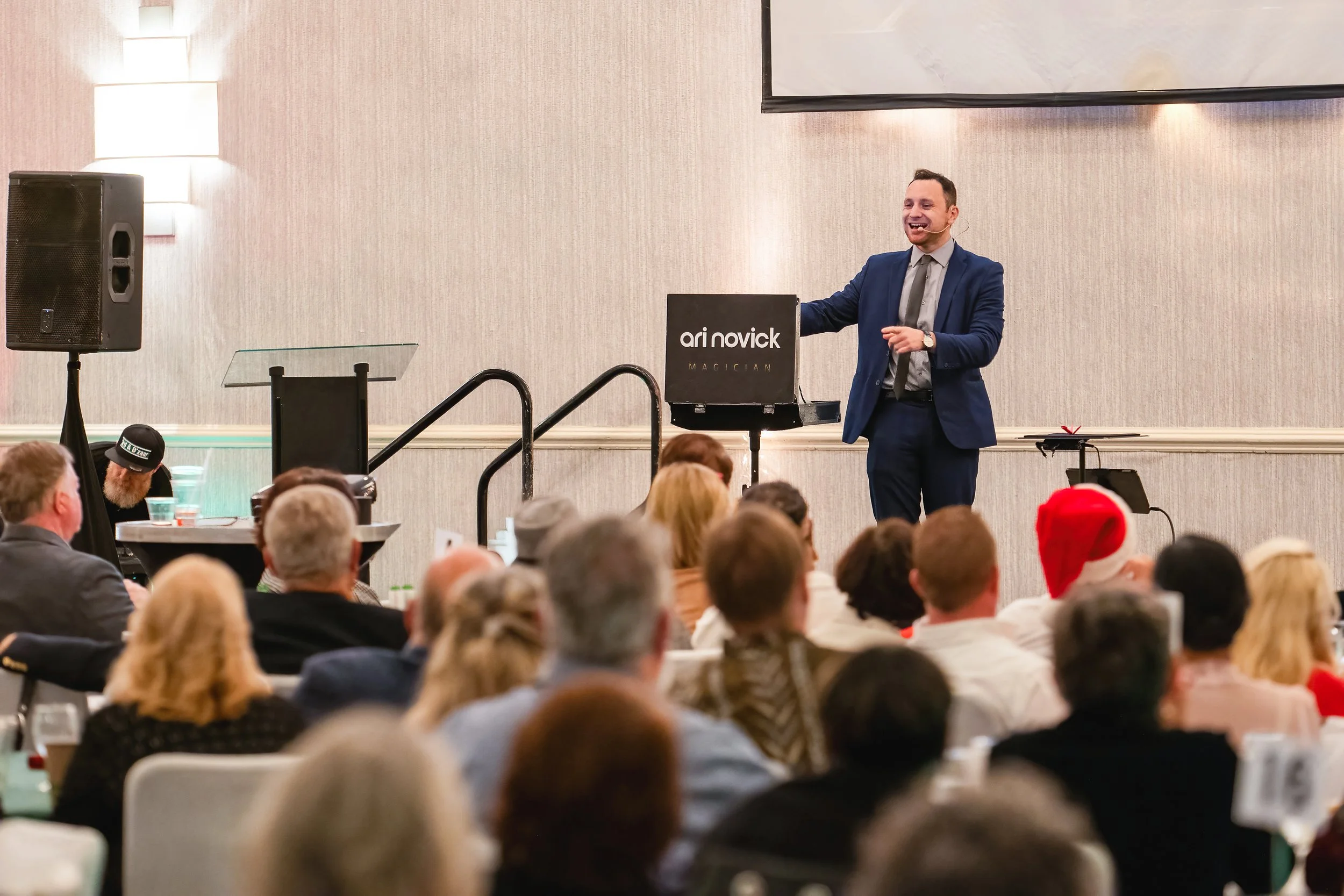 Corporate magician Ari Novick performing at a corporate event in Coral Gables, Florida.