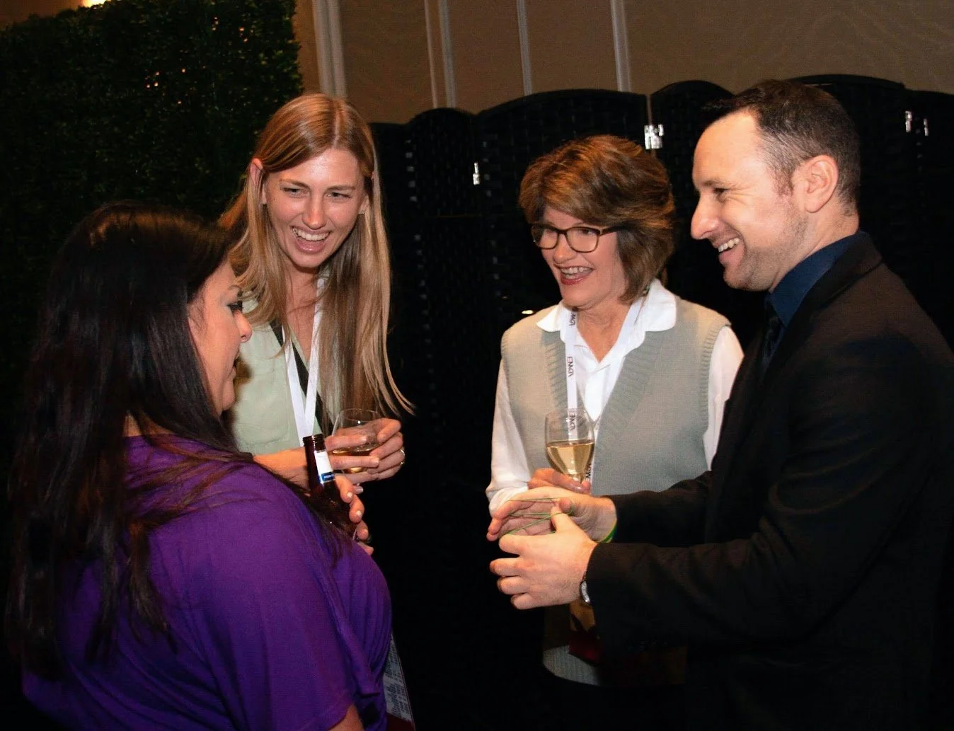 Corporate magician Ari Novick entertaining employees and guests with interactive close-up magic at a company event in Orlando, Florida.